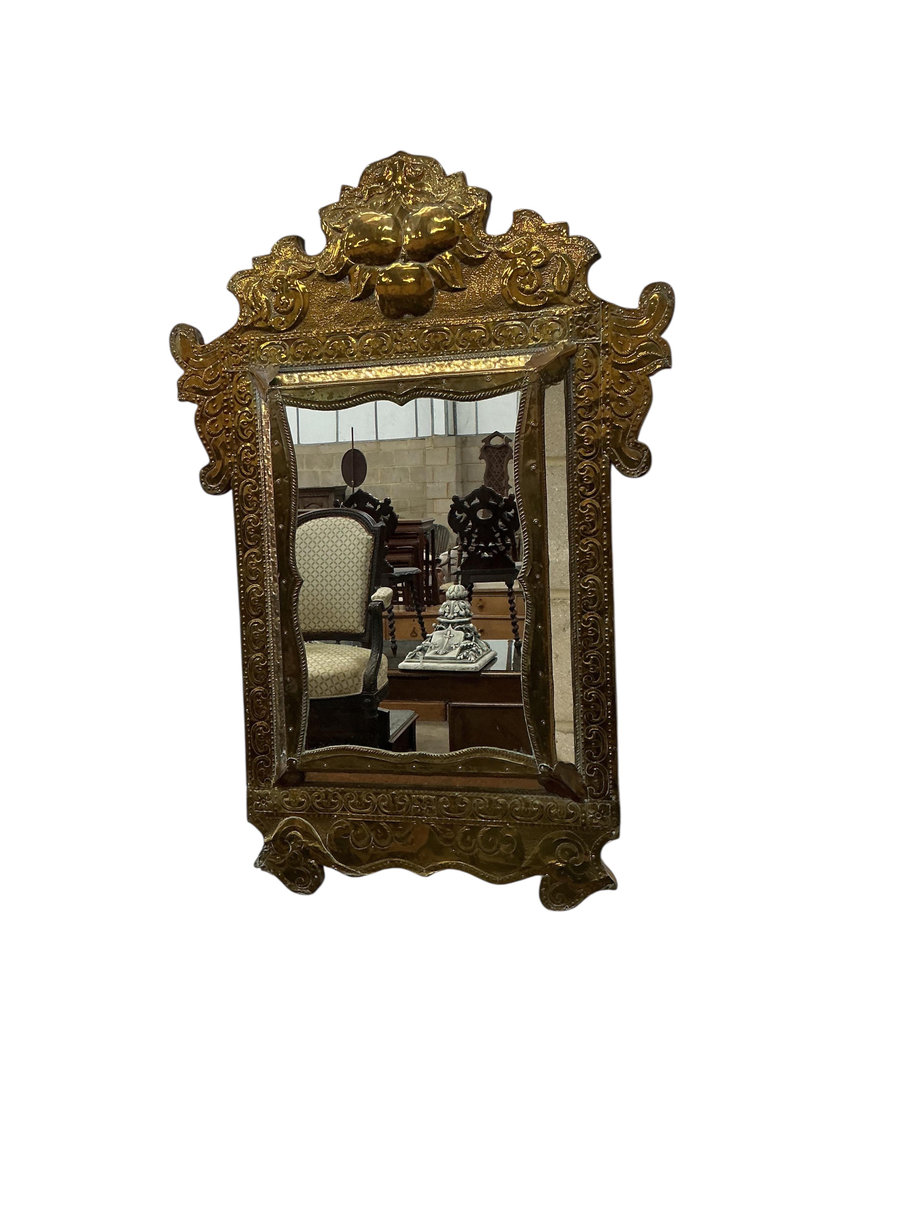 A pair of Eastern embossed brass wall mirrors, width 57cm, height 82cm